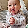 baby, smile, clothing, infant, blanket, cushion, happy, indoors, face, person, cute, sitting, pattern, cozy, child, hands, expression, home, cute_outfit, soft