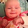 baby, blanket, chubby, closeup, clothing, cozy, cute, face, fist, hands, happy, hearts, indoor, infant, pink, portrait, red, smiling, soft, sparkle
