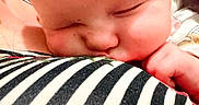 Hope joined the competition — help win amazing prizes! baby, blanket, close_up, colorful, comfort, cute, face, hand, head, indoor, infant, peaceful, portrait, resting, skin, sleeping, soft_texture, striped_clothing, tender_moment, young_child
