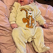 Oliver joined the competition — help win amazing prizes! baby, infant, onesie, tigger, smile, happy, cozy, bed, blanket, soft, cute, child, sleepwear, lying_down, pajamas, face, person, bedroom, comfort, fabric