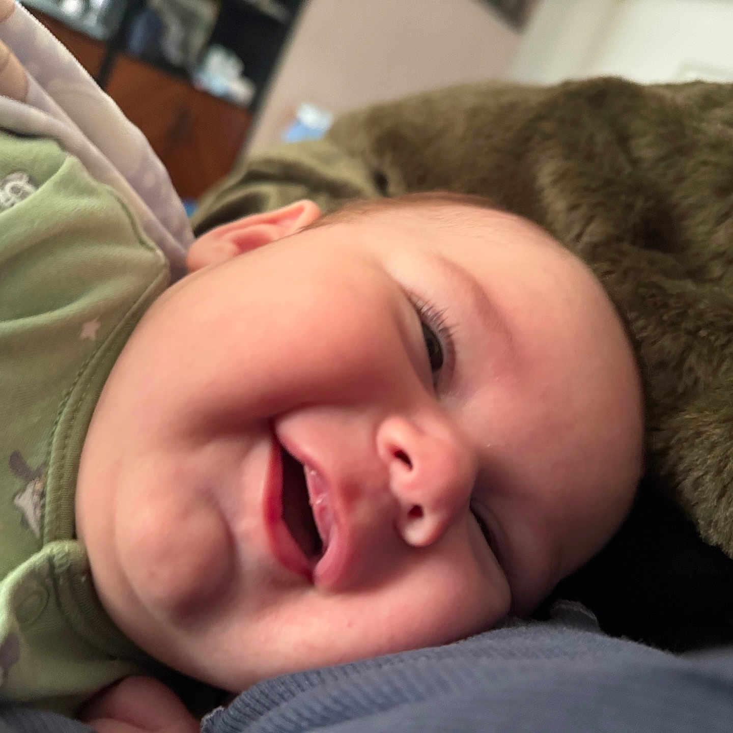 Simeon joined the competition — help win amazing prizes! baby, babylaughing, blanket, bodypart, clothing, cushion, face, happy, head, homedecor, hood, laughing, mouth, newborn, person, photography, portrait, sleeping, smile