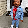 Shahaad is registered to the contest to win money with this photo: child, toddler, smiling, denim_jacket, red_shirt, plaid, jeans, sneakers, porch, concrete, door, brick_wall, outdoor, fashion, happy, cute, person, standing, footwear, casual