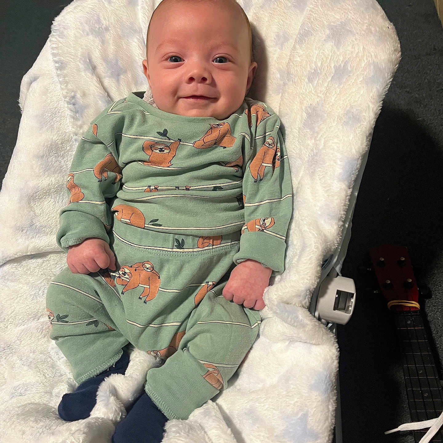 Ezra is registered to the contest to win money with this photo: architecture, baby, bed, blanket, building, clothing, cushion, face, furniture, glove, guitar, happy, head, homedecor, musicalinstrument, newborn, person, photography, portrait, smile
