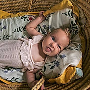 Myra Dale joined the competition — help win amazing prizes! baby, infant, basket, pillow, knitted_outfit, cute, funny_face, tongue_out, expression, woven, fabric, blanket, indoor, child, person, head, skin, comfort, lying_down, soft