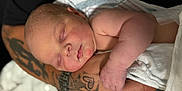 Colton is registered to the contest to win money with this photo: baby, newborn, sleeping, infant, arm, tattoo, blanket, skin, hand, closeup, peaceful, resting, portrait, human, person, soft, cozy, cute, baby_skin, wrapped