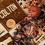 baby, infant, pacifier, camo_clothing, onesie, blanket, animal_print, wooden_marker, milestone, one_month, newborn, face, person, lying_down, indoors, soft_texture, cute, sleepwear, child, resting