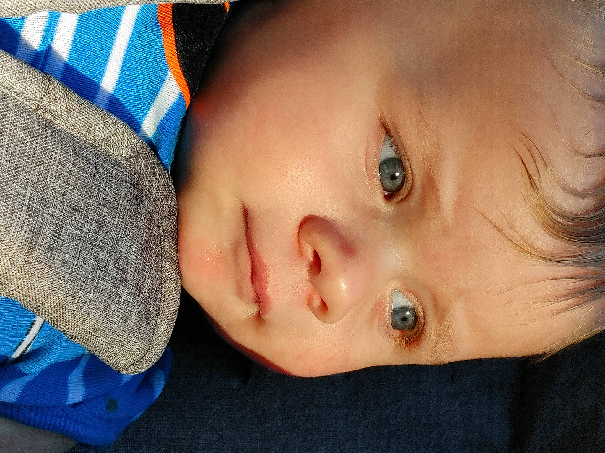 Bryan is registered to the contest to win money with this photo: baby, blue, cap, cheek, chin, eye, eyebrow, eyelash, face, facial_expression, headgear, human, human_body, iris, lip, neck, nose, person, skin, smile