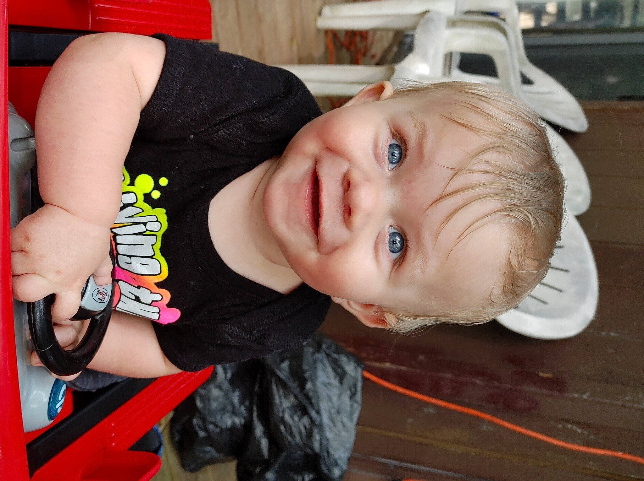 Bryan is registered to the contest to win money with this photo: baby, baby_toddler_clothing, cheek, child, elbow, fun, happy, iris, joy, leisure, lip, mouth, nose, person, sitting, sleeve, smile, standing, t_shirt, toddler