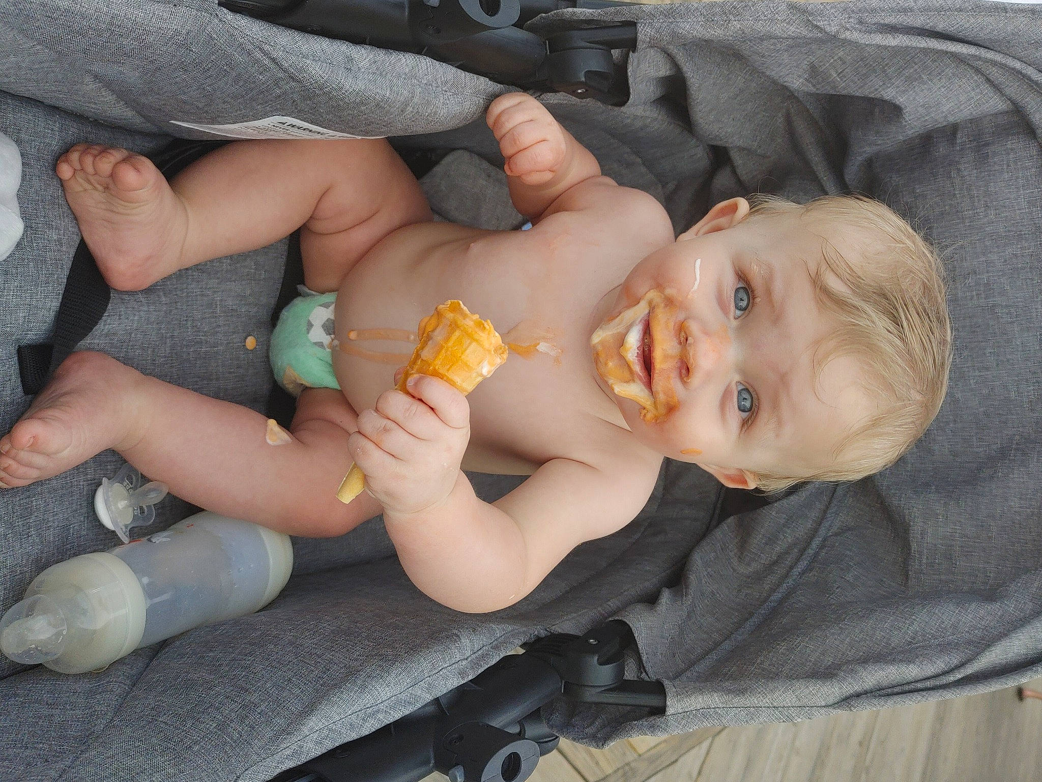 Bryan is registered to the contest to win money with this photo: baby, baby_carriage, baby_products, baby_toddler_clothing, car_seat, child, comfort, finger, gesture, grass, hand, lap, mouth, nail, person, skin, smile, sock, textile, thumb