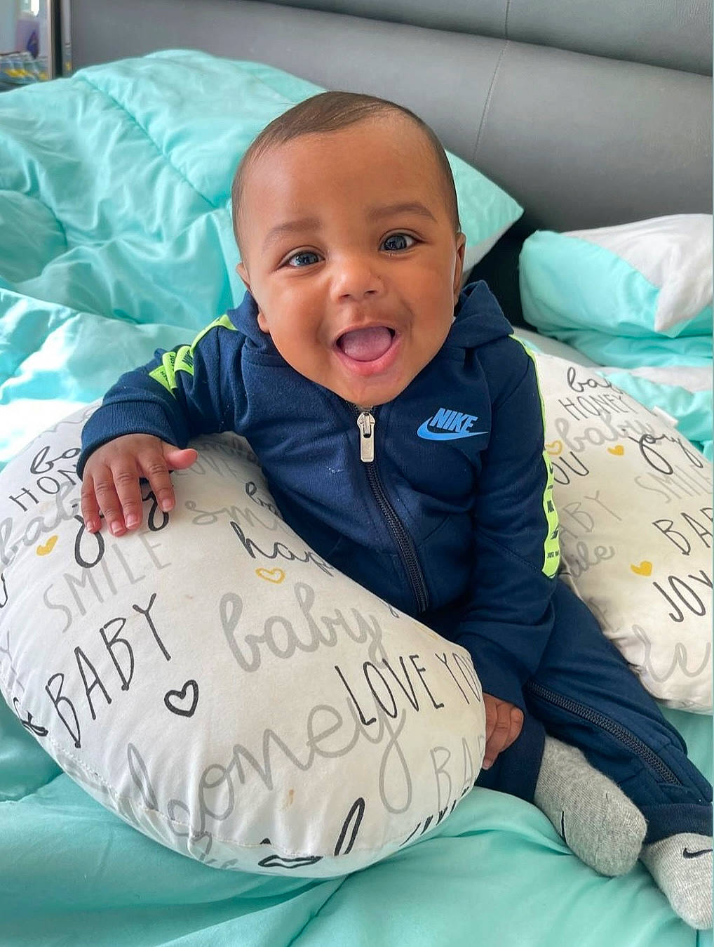 Amiri joined the competition — help win amazing prizes! baby, baby_products, baby_toddler_clothing, bedding, child, comfort, event, facial_expression, fun, handwriting, happy, linens, person, product, sitting, sleeve, smile, t_shirt, textile, toddler