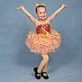 Lily is registered to the contest to win money with this photo: child, girl, ballet, dance, tutu, dress, smile, pose, performance, costume, studio, blue_background, black_shoes, happy, young, cheerful, arms_up, headband, dancewear, portrait