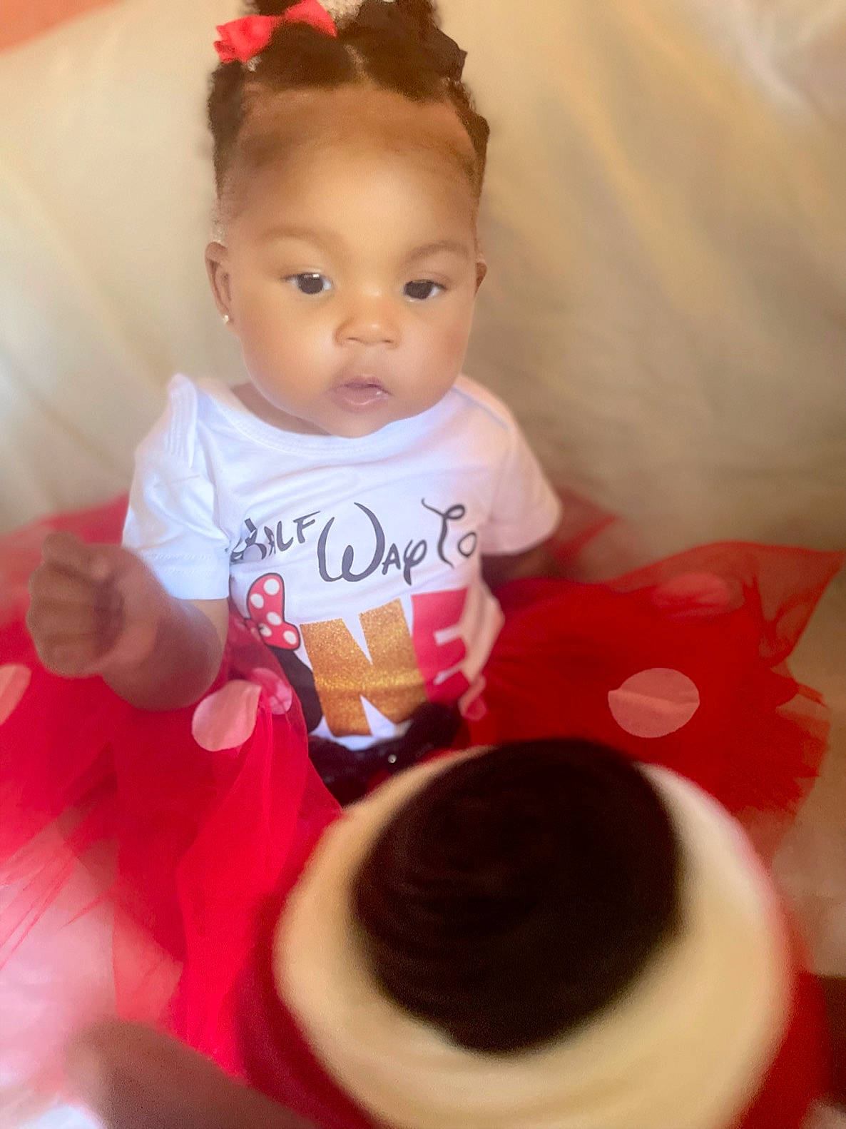 Kai is registered to the contest to win money with this photo: baby, baby_toddler_clothing, cheek, child, fashion_accessory, finger, happy, headgear, lip, magenta, neck, peach, person, pink, red, skin, sleeve, sweetness, t_shirt, textile