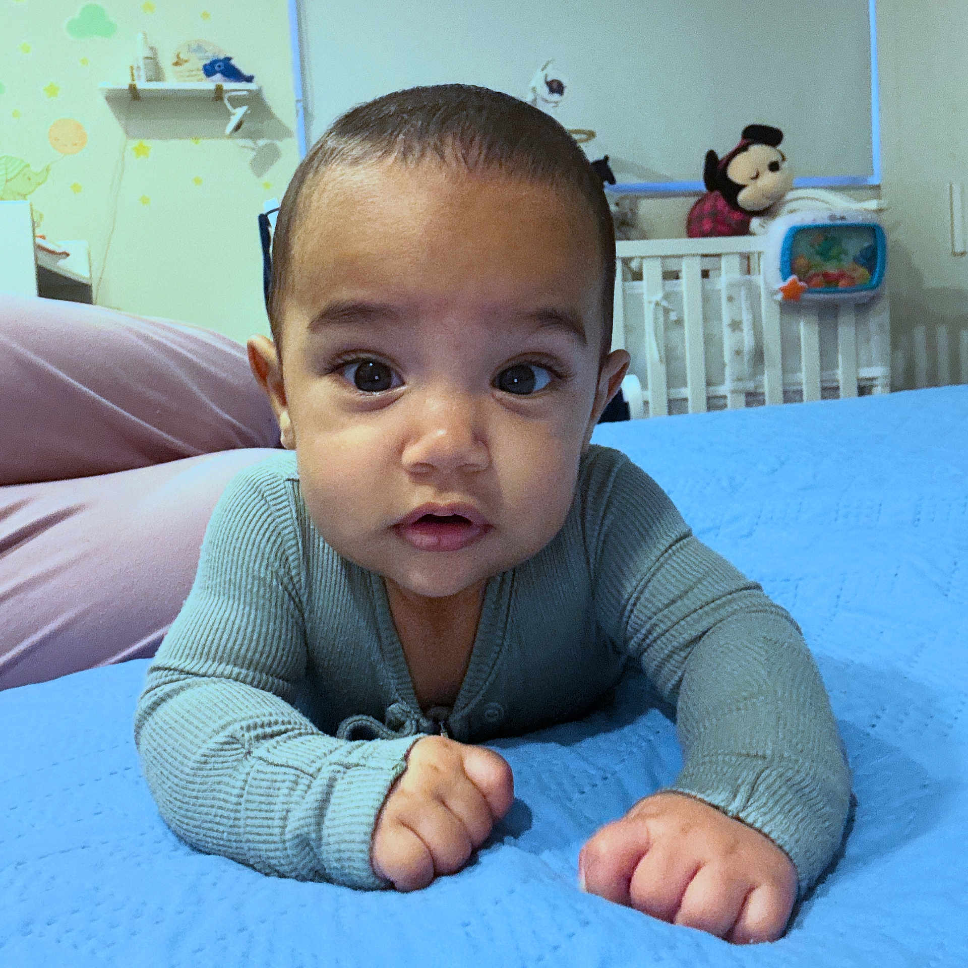 Dylan is registered to the contest to win money with this photo: baby, infant, child, face, eyes, hands, clothing, bed, blanket, nursery, crib, stuffed_toy, toy, indoor, portrait, cute, expression, skin, room, person