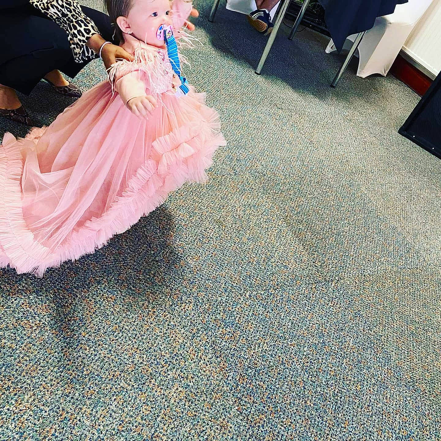 Amalia is registered to the contest to win money with this photo: baby_toddler_clothing, black, child, day_dress, dress, event, fashion_accessory, fashion_design, flooring, formal_wear, gown, happy, human_body, human_leg, leg, pattern, person, ruffle, sitting, textile