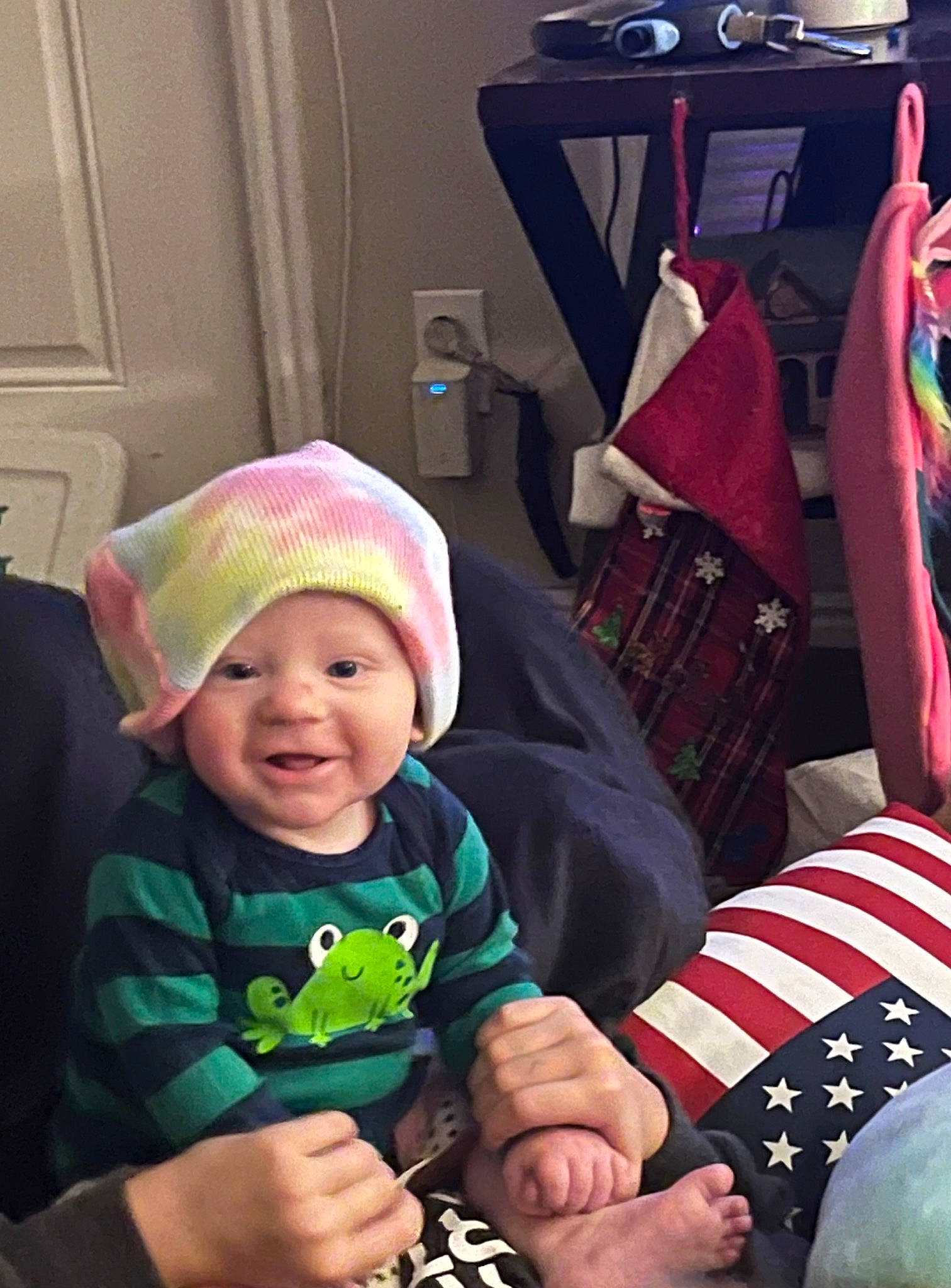 Noah is registered to the contest to win money with this photo: baby, beanie, cap, child, door, event, fashion_accessory, flag, flag_day_usa, flag_of_the_united_states, fun, gesture, happy, headwear, helmet, holiday, lap, person, personal_protective_equipment, sitting