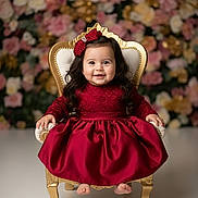 Sophie a rejoint le concours — aidez-le/la à gagner de superbes lots ! baby, child, dress, red_dress, bow, chair, golden_chair, smile, happy, portrait, indoor, flower_background, long_hair, cute, infant, elegant, sitting, fancy, photography, adorable