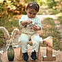 toddler, child, outdoor, nature, grass, dirt_path, wooden_stool, number_one, vase, pampas_grass, curious, sitting, clothing, sneakers, portrait, daylight, greenery, focus, cute, baby