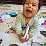 baby, child, clothing, colorful, crawling, cute, expression, face, fun, hands, happy, indoor, infant, joy, pattern, play_mat, portrait, smiling, toy, young