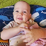 Bella Wynter joined the competition — help win amazing prizes! baby, babylaughing, blanket, bodypart, clothing, cushion, face, finger, furniture, hand, happy, head, homedecor, newborn, person, photography, portrait, quilt, smile, t_shirt