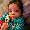 Ryan Christopher is registered to the contest to win money with this photo: baby, child, infant, portrait, face, eyes, curious, indoor, sitting, toy, stuffed_animal, teal_clothing, colorful, pillow, couch, cozy, hands, dark_hair, looking_at_camera, closeup