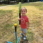 Wyatt joined the competition — help win amazing prizes! child, boy, smiling, baseball_bat, tee_ball, yellow_ball, grass, field, shorts, tshirt, sneakers, outdoor, daylight, trees, sports, play, recreation, happy, standing, sunny
