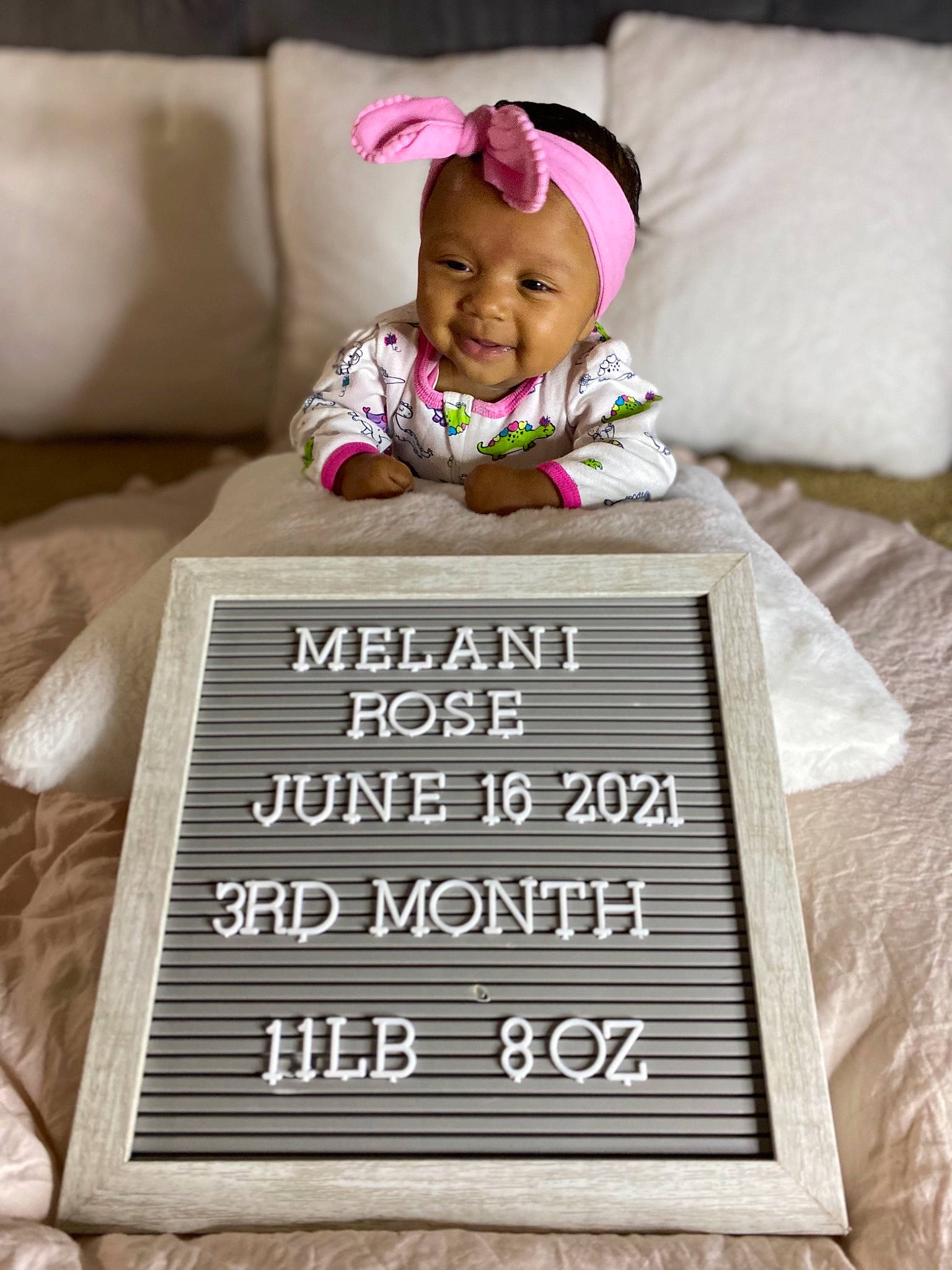 Melani is registered to the contest to win money with this photo: baby, baby_laughing, baby_toddler_clothing, child, comfort, couch, design, face, font, happy, headwear, linens, magenta, person, product, rectangle, room, sleeve, smile, t_shirt