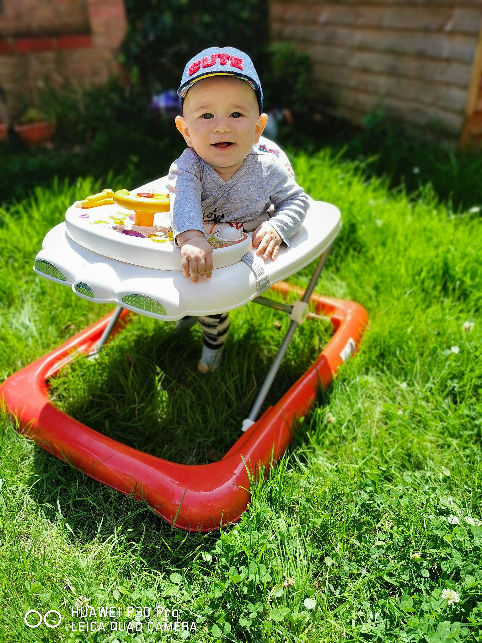 Matei is registered to the contest to win money with this photo: child, grass, headwear, lawn, leisure, person, plant, play, sitting, toddler, vehicle, yard