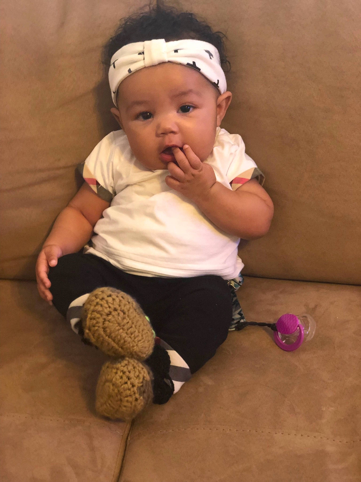 Reign is registered to the contest to win money with this photo: baby, baby_products, baby_toddler_clothing, cheek, child, finger, hair_accessory, headband, headgear, headwear, leg, person, product, sitting, skin, toddler