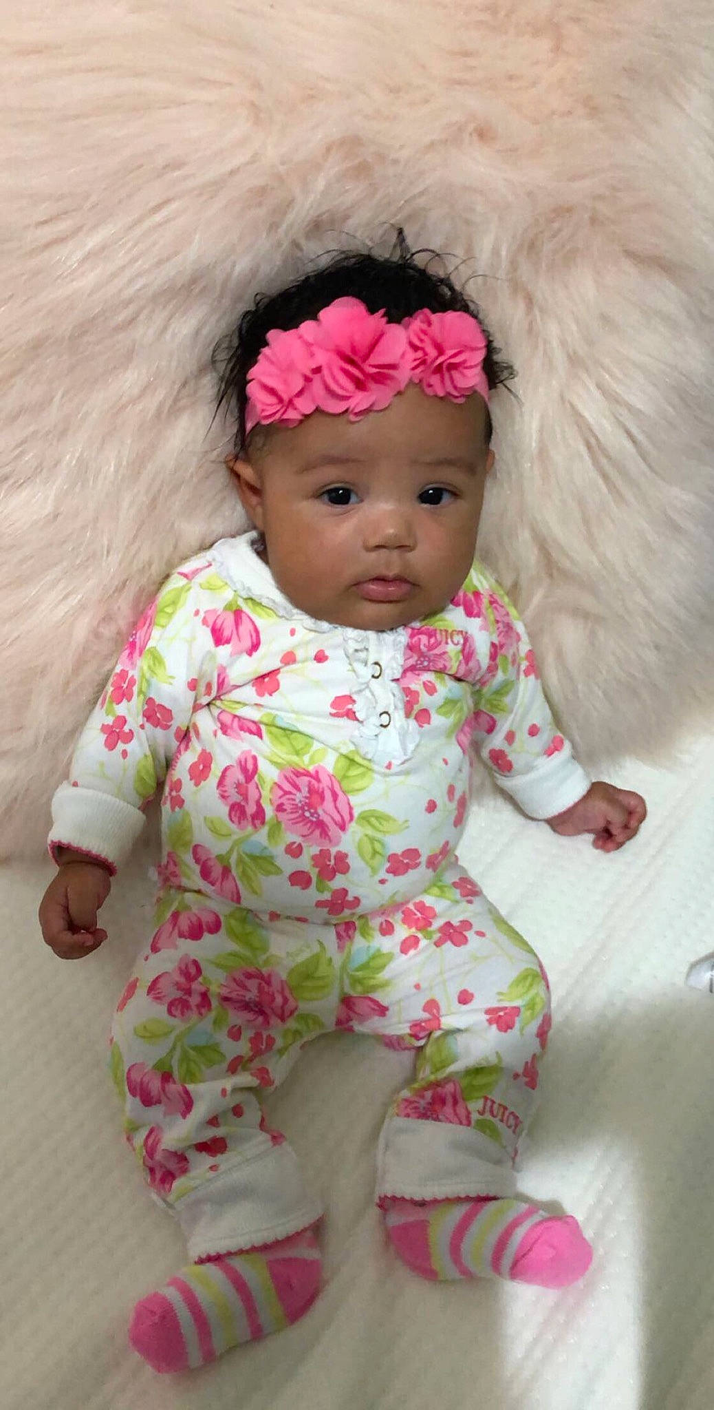 Reign is registered to the contest to win money with this photo: baby, baby_products, baby_toddler_clothing, brown_hair, cheek, child, doll, hair_accessory, headband, headgear, headwear, person, pink, product, skin, toddler, toy