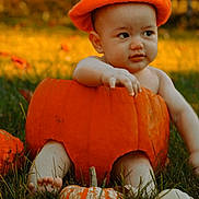 Gadiel joined the competition — help win amazing prizes! baby, pumpkin, orange, grass, outdoor, child, cute, fall, autumn, hat, nature, smiling, sitting, seasonal, playful, person, young, harvest, fun, costume