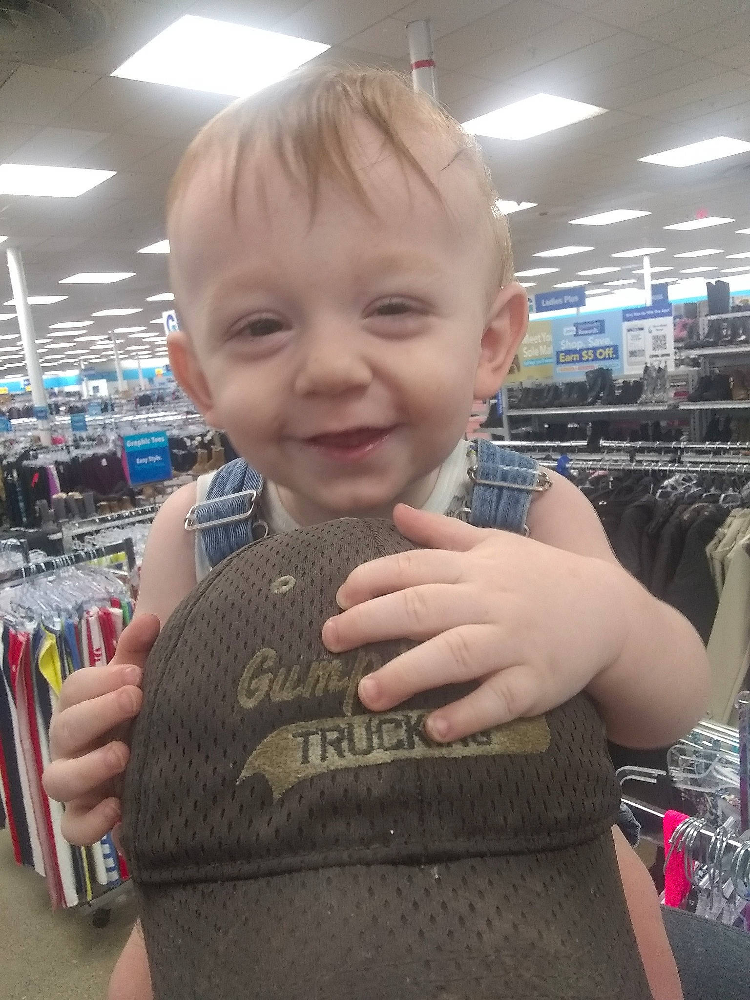 Caleb is registered to the contest to win money with this photo: baby, child, chin, cool, fun, gesture, happy, joy, nail, person, product, retail, shopping, skin, sleeve, smile, standing, t_shirt, thumb, toddler