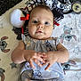 baby, infant, child, blanket, plush_toy, pacifier, clothing, cute, lying_down, hands, face, eyes, indoors, soft_toy, patterned_clothing, carpet, comfort, adorable, young_child, expression