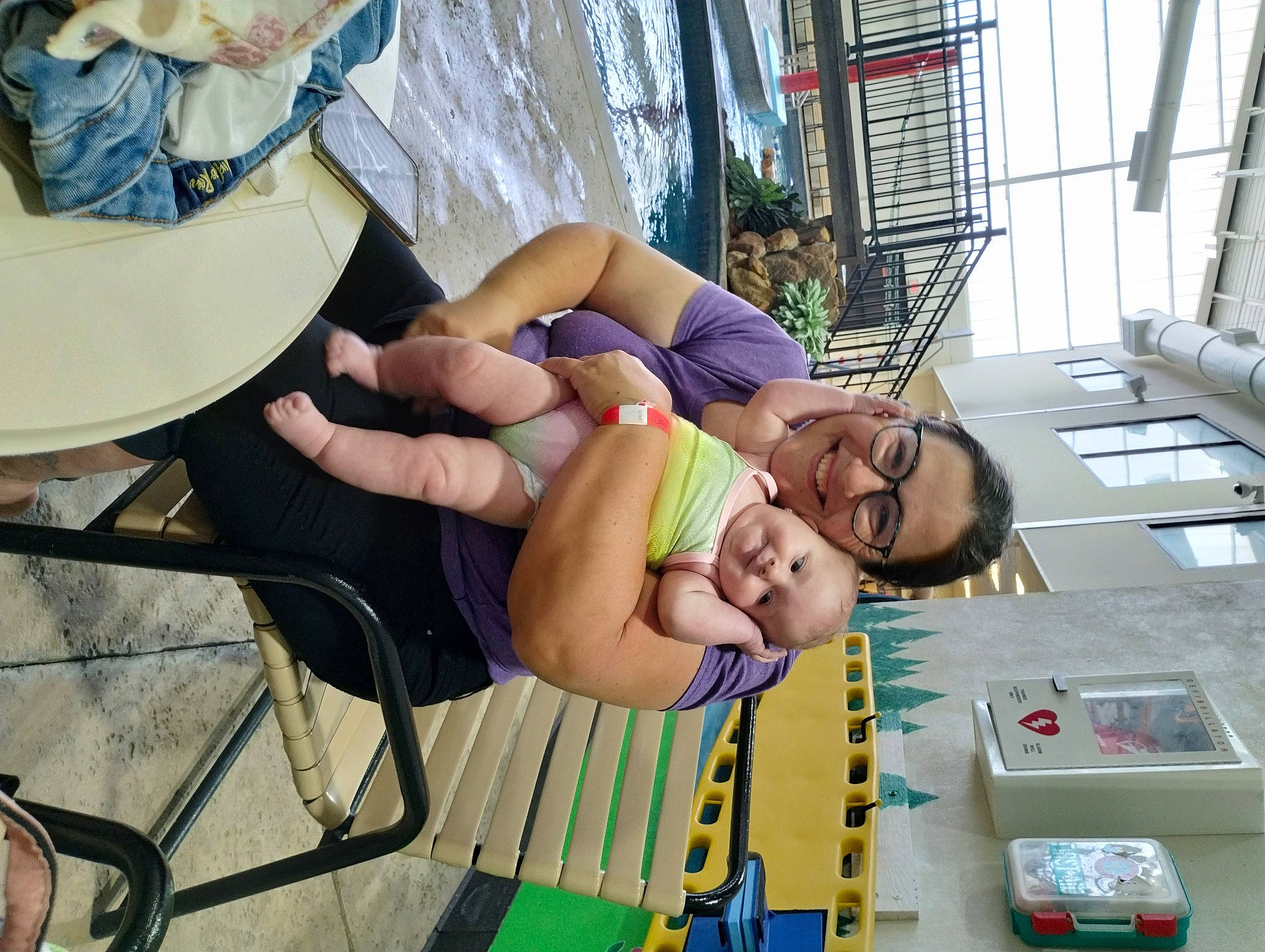 Madelyn is registered to the contest to win money with this photo: barechested, box, chair, child, eyewear, flooring, fun, hat, human_leg, joy, knee, leisure, person, plant, recreation, room, shorts, smile, thigh, tourism