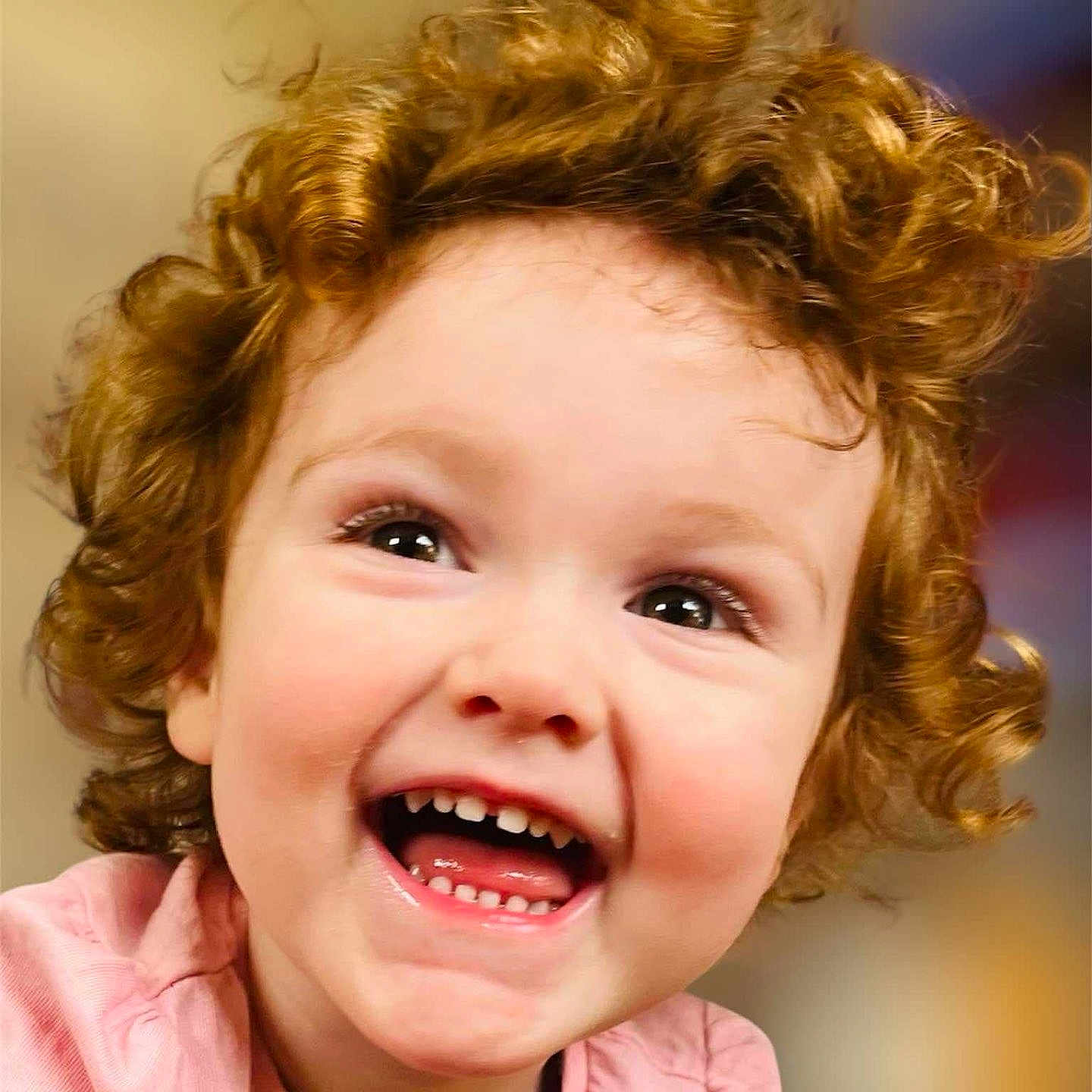 Evelyn-Rose is registered to the contest to win money with this photo: child, closeup, curly_hair, cute, emotion, expression, eyes, face, happy, head, indoor, joyful, person, pink_shirt, portrait, skin, smiling, teeth, toddler, young