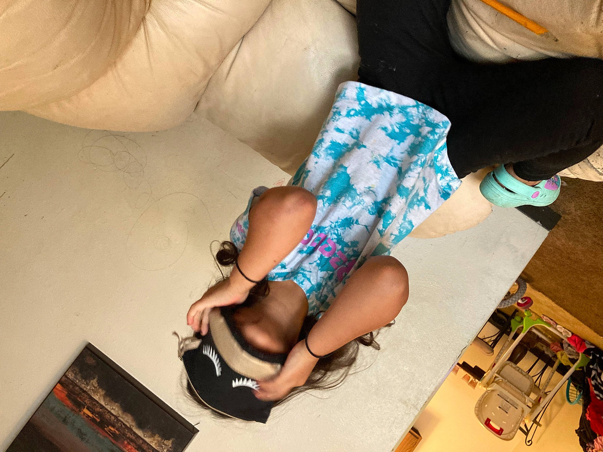 Leanne Rae is registered to the contest to win money with this photo: barefoot, comfort, elbow, finger, foot, human_leg, joint, knee, lap, leg, linens, nail, pattern, person, picture_frame, room, sandal, sitting, sock, thigh