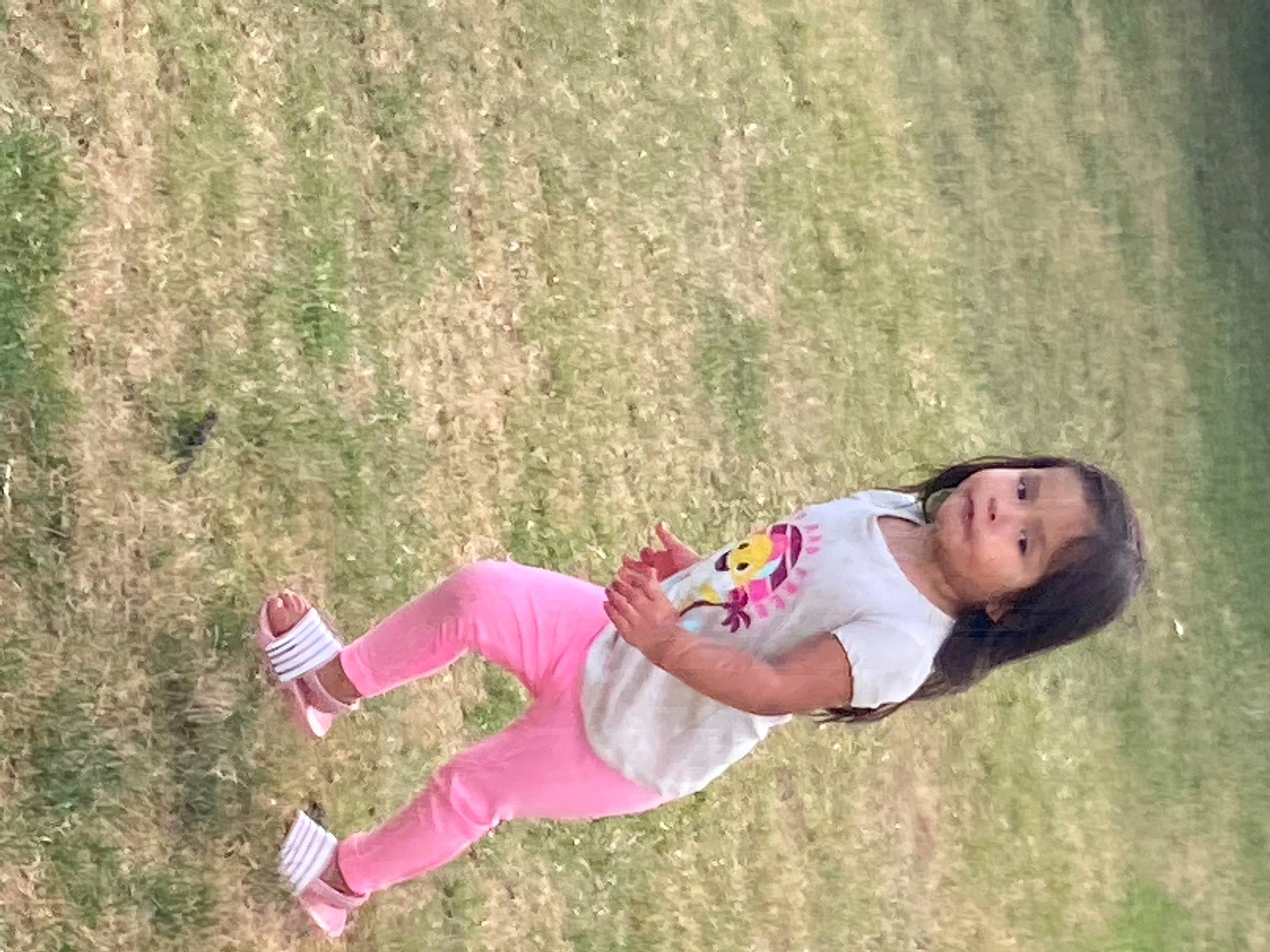 Leighlah is registered to the contest to win money with this photo: arm, clothing, fun, grass, grass_family, grassland, happy, human_leg, knee, lawn, leg, leisure, meadow, people_in_nature, person, plant, recreation, shoe, sneakers, thigh