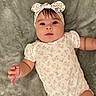 Alisson joined the competition — help win amazing prizes! baby, infant, child, portrait, lying_down, smiling, face, headband, bow, floral_clothing, onesie, blanket, gray_blanket, indoor, closeup, arms, hands, legs, cute, photography