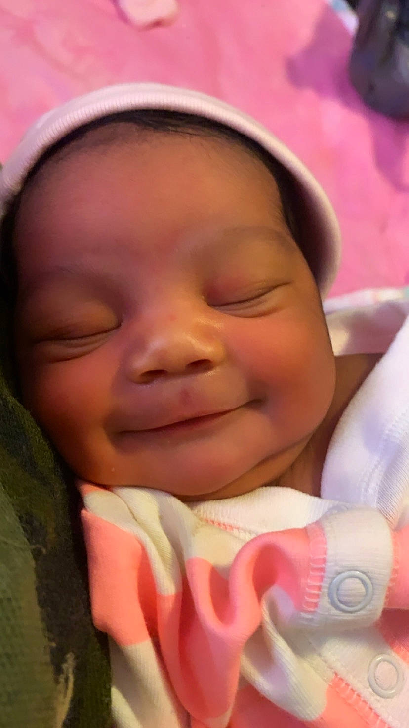 Alaiyah is registered to the contest to win money with this photo: baby, baby_toddler_clothing, cheek, chin, eyebrow, face, facial_expression, finger, forehead, happy, head, lip, mouth, muscle, nose, person, pink, skin, smile, thumb