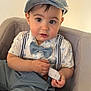 Alexander joined the competition — help win amazing prizes! toddler, child, boy, cap, bow_tie, suspenders, shirt, pants, cushion, chair, indoor, portrait, cute, curious, small_hands, clothing, face, eyes, seated, baby