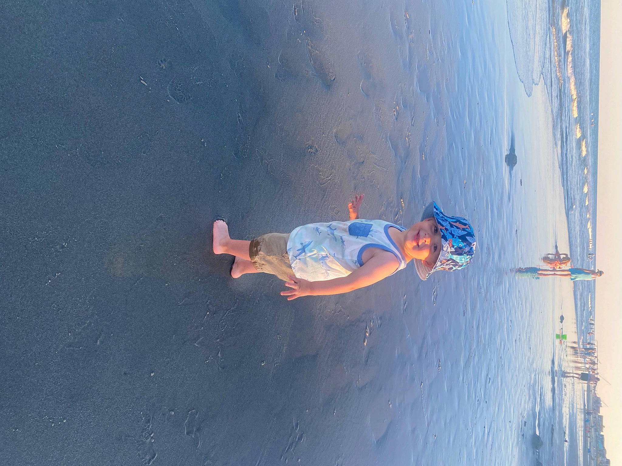 Clayton is registered to the contest to win money with this photo: adventure, arm, asphalt, beach, body_of_water, cloud, elbow, electric_blue, fun, headwear, joy, landscape, leisure, ocean, person, recreation, shadow, sky, vehicle_door, water