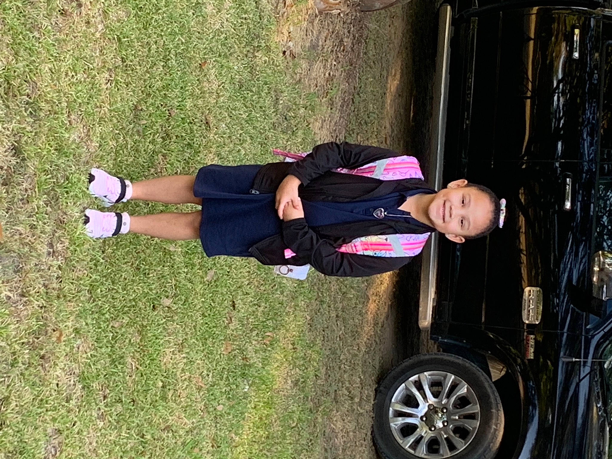 Emerie is registered to the contest to win money with this photo: automotive_design, automotive_exterior, automotive_tire, car, fender, grass, hubcap, joy, motor_vehicle, person, rim, rolling, smile, sneakers, synthetic_rubber, tire, tire_care, tread, vehicle, vehicle_door