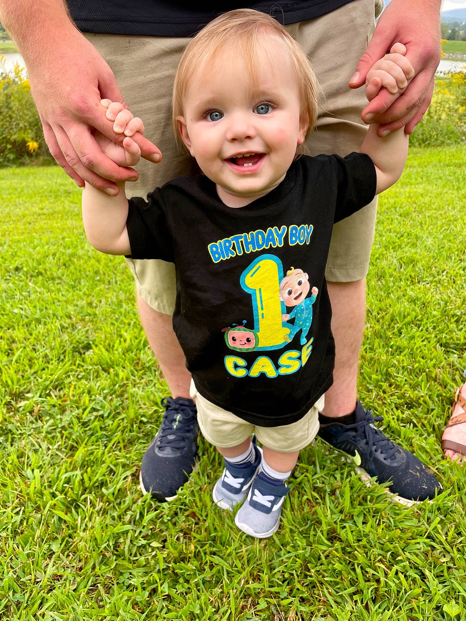 Case is registered to the contest to win money with this photo: baby, baby_toddler_clothing, child, eye, finger, footwear, gesture, grass, hair, hand, happy, head, joy, people, people_in_nature, person, plant, shorts, sleeve, smile