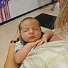 James is registered to the contest to win money with this photo: baby, sleeping, person, arms, indoor, balloons, face, profile, holding, child, toddler, skin, hair, clothing, hand, peaceful, closeup, infant, young, casual
