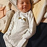 James is registered to the contest to win money with this photo: baby, sleeping, onesie, sloth, infant, blanket, bed, cozy, cute, child, newborn, soft, comfort, face, peaceful, clothing, resting, indoors, portrait, person