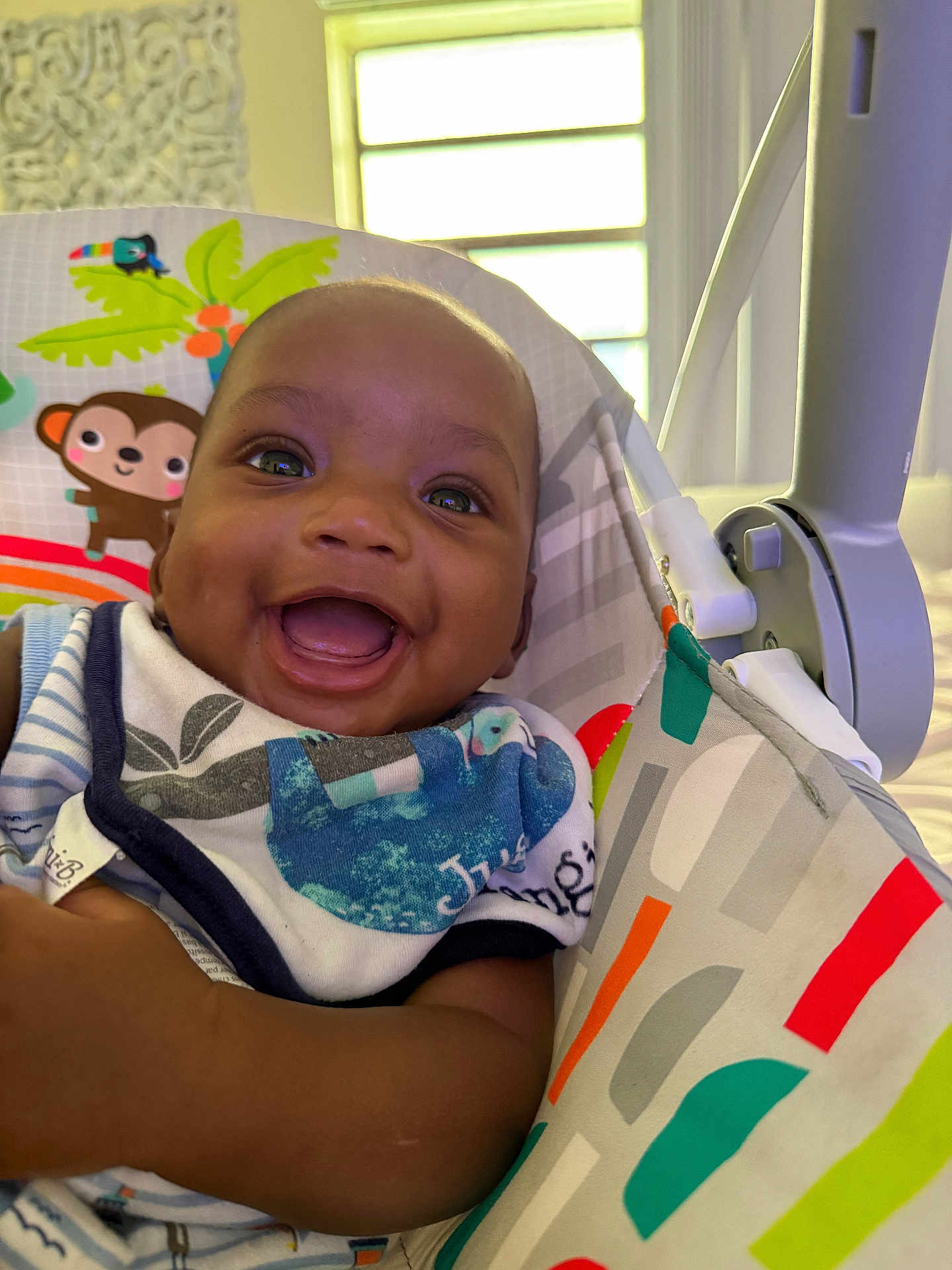 Sincere joined the competition — help win amazing prizes! baby, smile, happy, infant, child, face, seat, colorful, pattern, clothing, bib, indoor, toy, monkey, tropical, window, arm, skin, cute, portrait