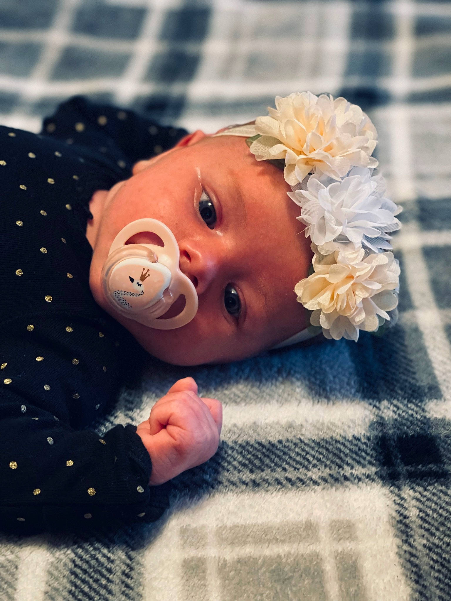 Anna is registered to the contest to win money with this photo: baby, baby_products, baby_toddler_clothing, child, close_up, facial_expression, fashion_accessory, finger, flooring, flower, fun, happy, headpiece, headwear, linens, pattern, peach, person, petal, skin