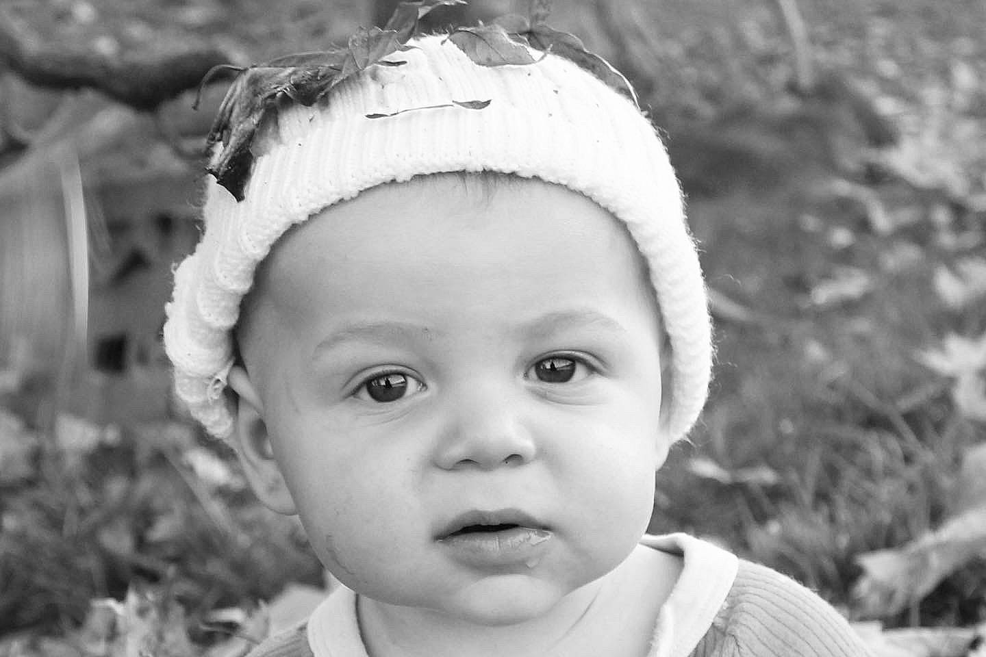 Beckham is registered to the contest to win money with this photo: black_and_white, cheek, eyebrow, eyelash, flash_photography, grass, happy, human_body, iris, lip, monochrome, monochrome_photography, organ, people_in_nature, person, plant, skin, smile, style, toddler