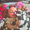 baby, blanket, infant, filter, face, baby_seat, cushion, indoor, cozy, soft, child, colorful_filter, leopard_print, playful, toddler, clothing, person, comfort, resting, wrapped