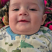 Valentino is registered to the contest to win money with this photo: baby, infant, smiling, face, onesie, animal_print, blanket, colorful, cute, child, cozy, portrait, happy, person, indoors, soft, clothing, pattern, young, babywear