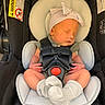 newborn, baby, sleeping, car_seat, hat, sock, infant, child, seatbelt, safety, cute, small, resting, clothing, headgear, indoors, person, transportation, child_seat, peaceful